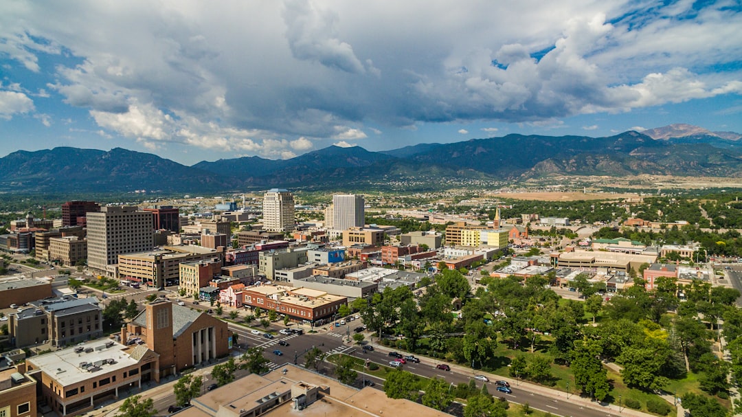 Aerial view of a downtown business district with mountains rising behind